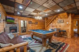 a living room with a pool table and a fireplace at Luxury Cabin • 4 King Beds • Jacuzzi in Each Room in Cartertown