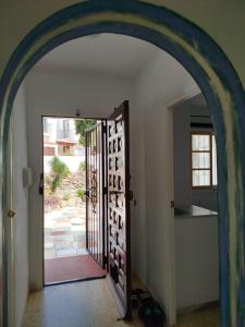an archway leading to a door with wine bottles at Apartament Maria F in Mojácar