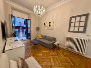 a living room with a couch and a table at PAMPLONA CENTER SUITES luxury apartament City center in Pamplona