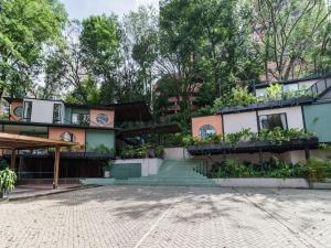 a building with a lot of plants on it at The Box by Wynwood House in El Salvador