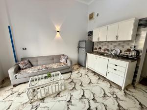 a living room with a couch and a kitchen at Nile View House in Luxor