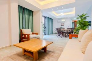 a living room with a couch and a table at El Sheikh Zayed in Sheikh Zayed