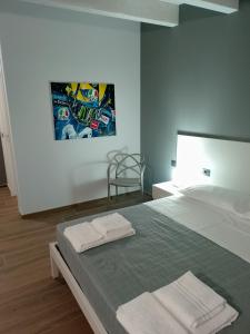 a bedroom with a bed with two towels on it at Montecarlo B&B in Tortona