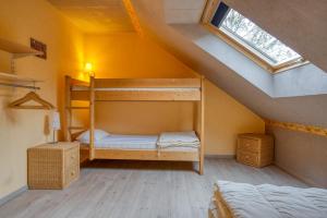 a bedroom with bunk beds in a attic at Villa La Chauve Souris in Houffalize +54 photos