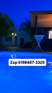 een zwembad voor een huis 's nachts bij a Casa Paradisiaca lll Luxo Com Sinuca e Lavanderia com Roupa de Cama e Toalhas in Caldas Novas