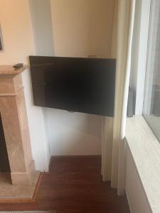 a flat screen tv hanging on a wall in a room at Franciscus in Bergen op Zoom