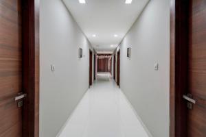 a hallway with white walls and a ceiling at Collection O Motipura Bus Terminal Formerly Hotel Navjivan in Himatnagar