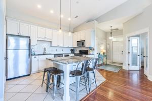 una cucina con armadi bianchi e un tavolo con sgabelli di Topsail Village 824 a Santa Rosa Beach Altre 23 foto