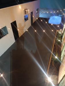 a large black table in a room with lights at Espaço jr in Andradina