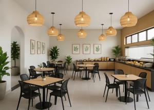 a restaurant with tables and chairs and pendant lights at Acqua Di Mare Pousada in Itanhaém