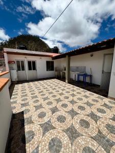 a patio with a tiled floor in front of a house at Modern, comfortable and convenient space in Sucre