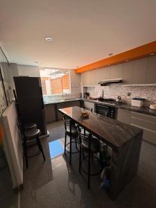 a kitchen with a island in the middle of it at Modern, comfortable and convenient space in Sucre +14 photos