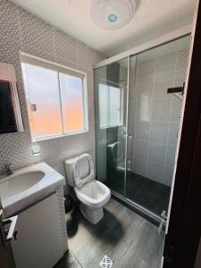 a bathroom with a toilet and a shower and a sink at Modern, comfortable and convenient space in Sucre