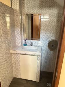 a bathroom with a sink and a mirror at Modern, comfortable and convenient space in Sucre