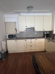 a kitchen with white cabinets and stainless steel appliances at Franciscus in Bergen op Zoom