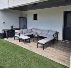 a living room with a couch and a table at Love Room - Cocon Room - Toulon - Ollioules in Ollioules