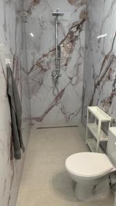 维也纳附近格拉斯多夫Business Park B7的浴室配有白色卫生间和大理石墙。