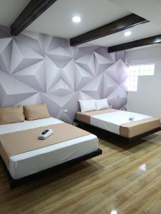 Una cama o camas en una habitación de Hotel Oro VIP Pereira