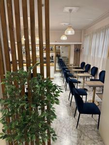 a row of tables and chairs in a restaurant at Hotel La Pace in Pontedera +70 photos