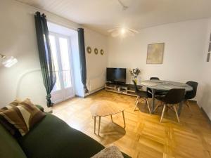 a living room with a couch and a table at Appartement T3 en duplex Veynes in Veynes