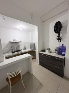 a kitchen with a table and a chair in it at Hostal Shaddai in Manta