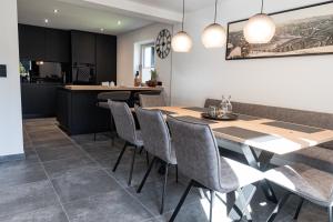 a kitchen and dining room with a table and chairs at Rupertichalet in Zell am See