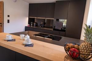 a kitchen with a counter with a bowl of fruit on it at Rupertichalet in Zell am See +23 photos