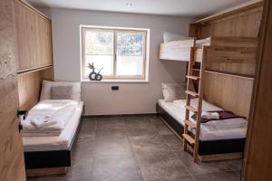 a room with two bunk beds and a window at Rupertichalet in Zell am See