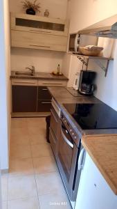 a kitchen with a stove and a sink at Haus Broni in Prem