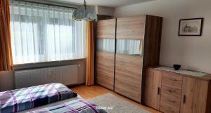 a bedroom with a large wooden cabinet and a window at Haus Broni in Prem
