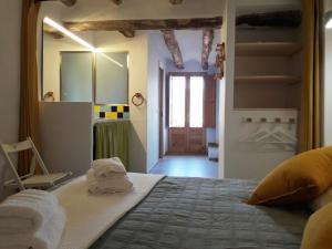 a bedroom with a large bed with towels on it at Casa cova de Benifallet in Benifallet