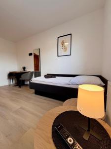 a bedroom with a bed and a table with a chair at Hotel & Pension Bockenem in Bockenem