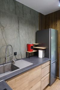 a kitchen with a sink and a refrigerator at Debri family in Krivopolʼye