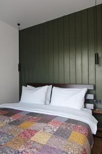 a bedroom with a bed with a quilt on it at Debri family in Krivopolʼye