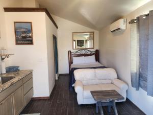 a room with a bed and a couch and a table at Sunrise Springs in Pahrump