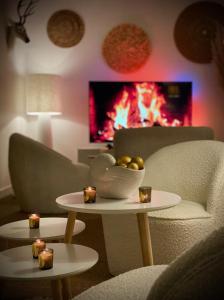 a living room with a fireplace and a table with candles at Maison Richet in Les Sables-dʼOlonne