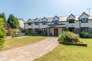 a large white house with a garden and a driveway at Barton Farm in West Down