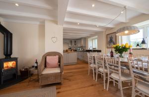 a dining room with a table and chairs and a fireplace at Barton Farm in West Down