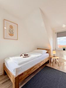 a bedroom with a bed and a window at Pension Bockenem in Bockenem