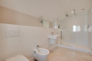 a white bathroom with a toilet and a shower at Barton Farm in West Down +62 photos
