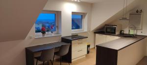 a kitchen with a counter and some chairs in it at Grüne Auszeit Dresden in Dresden