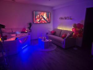 a purple living room with a couch and a fire pit at Love Room - Cocon Room - Toulon - Ollioules in Ollioules