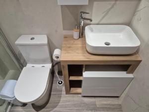 a bathroom with a white toilet and a sink at Dar il-Wied in Għajn il-Kbira +24 photos