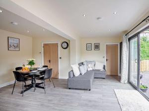 a living room with a table and a couch at 1 Bed in Conwy 96068 in Llangelynin