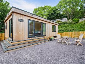 a tiny house with two chairs and a table at 1 Bed in Conwy 96068 in Llangelynin