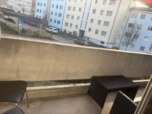 a balcony with a bench and a view of a street at Bern str 140 in Ostermundigen +13 photos