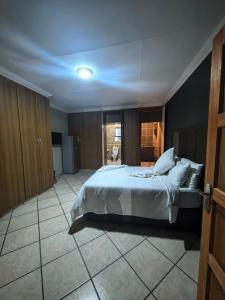 a bedroom with a large white bed in a room at The Good Samaritan 3 in Witbank