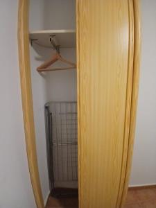 a wooden surfboard is standing in a closet at Luz del Guadiana in Ayamonte