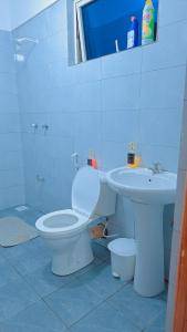 a bathroom with a toilet and a sink at Staycation One and Two Bedroom apartment Mombasa in Mombasa +18 photos