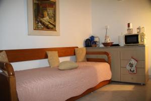 a bedroom with a bed and a tv on a counter at Cavo Paradise Kimolos in Kimolos